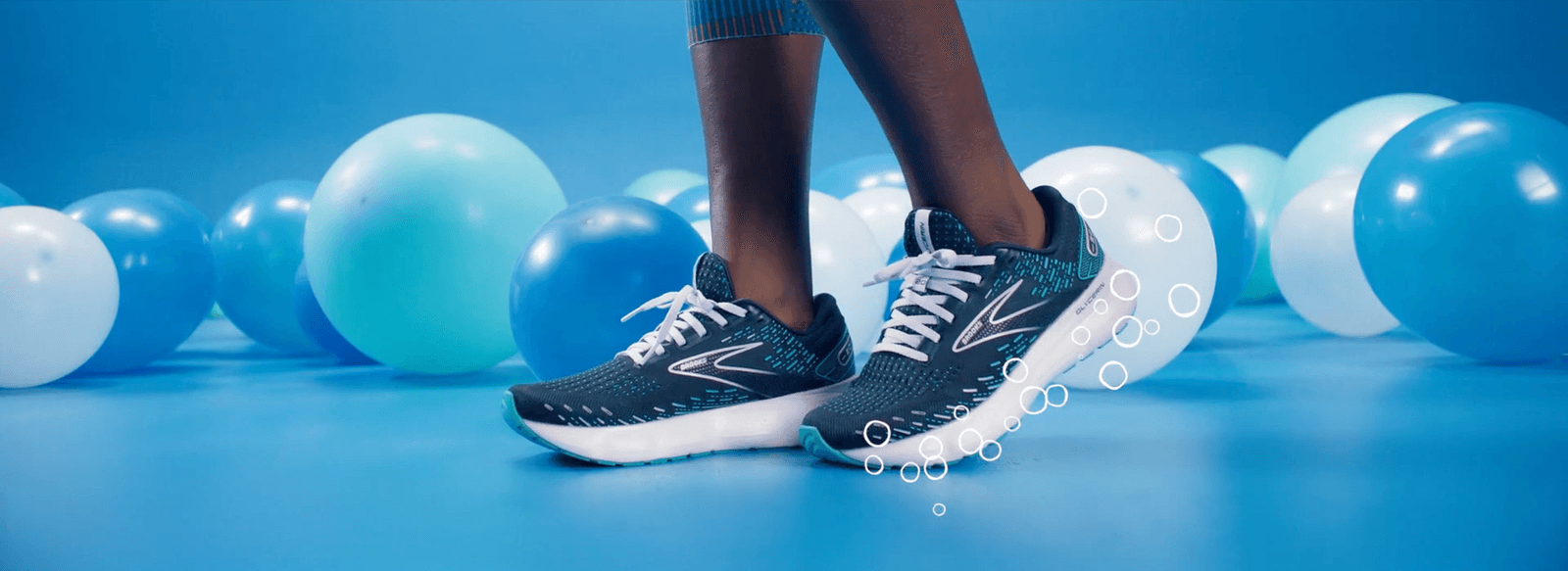 Brooks Glycerin shoes mid-stride among blue nitrogen bubbles