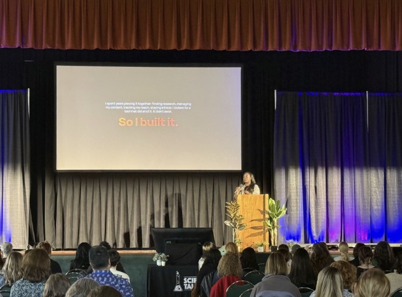 Dr. Raven Baxter delivering the opening keynote at Science Talk 2026, announcing Fervae onstage to a full audience