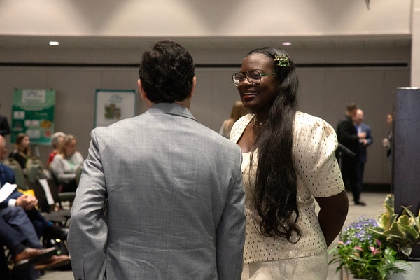 Dr. Raven Baxter in conversation with an attendee at Oklahoma Research Day